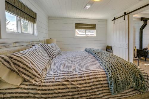 a bedroom with a bed with a blanket on it at Sunny Mears Vacation Rental with Private Beach! in Mears