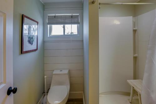 a bathroom with a toilet and a window at Sunny Mears Vacation Rental with Private Beach! in Mears