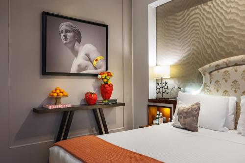 Ένα ή περισσότερα κρεβάτια σε δωμάτιο στο Singer Palace Hotel Roma