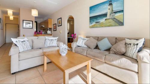 a living room with a couch and a table at Spacious contemporary apartment in Pissouri