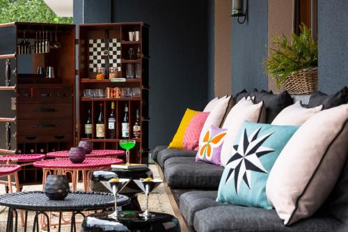 a living room with a couch with pillows and tables at Kristiania Lech in Lech am Arlberg