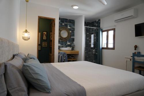 a bedroom with a large bed and a bathroom at La Pecera Altea in Altea