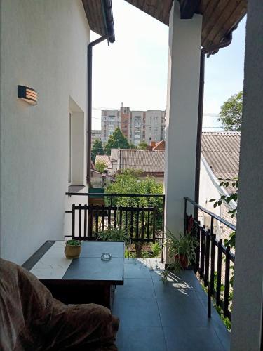 a balcony with a table and a view of a city at Family Apartments Dorobok in Lviv