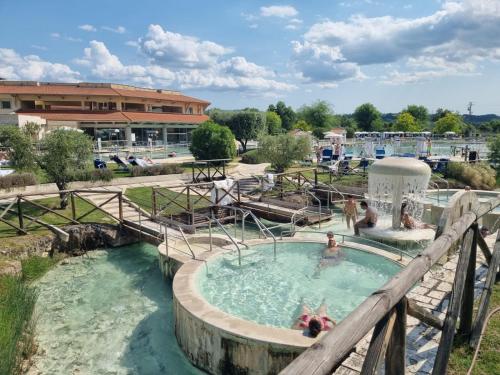 a pool at a water park with people in it at CASA MAIRA IN CENTRO A SATURNIA in Saturnia
