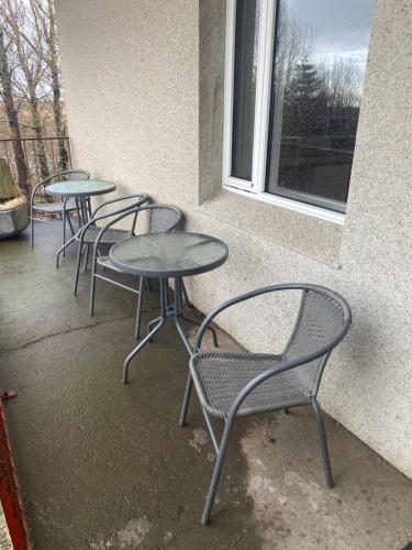 three tables and chairs sitting next to a window at Álftártunga Farm Guesthouse in Borgarnes