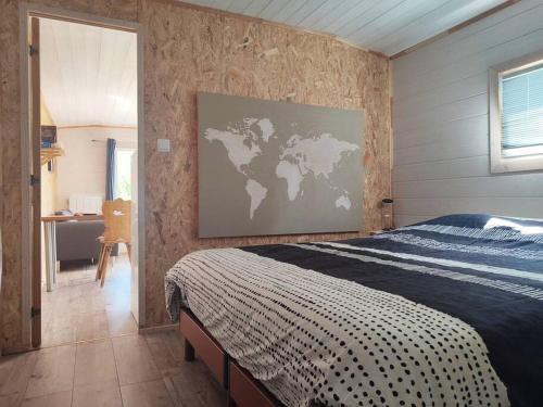 a bedroom with a bed and a map on the wall at Chalet Notcimick in Raon-sur-Plaine