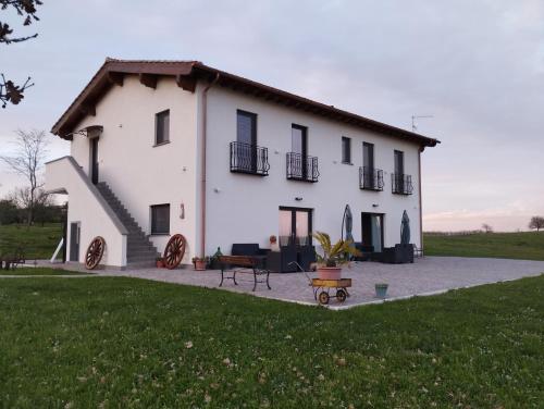 a large white house with a patio in front of it at Agriturismo Casale Lisalola in Sutri