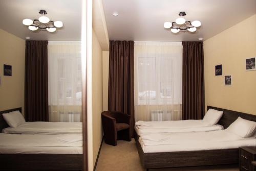 GagarInn Hotel tesisinde bir odada yatak veya yataklar