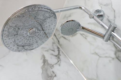 a shower with a shower head in a bathroom at Padstow townhouse, close to harbour in Padstow