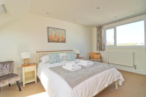 a bedroom with a bed with towels on it at Padstow townhouse, close to harbour in Padstow
