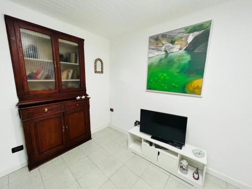 a living room with a tv and a cabinet at CASA BARBARA in Ventimiglia