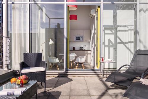 a balcony with chairs and a table on a building at Brera Serviced Apartments Munich West in Munich
