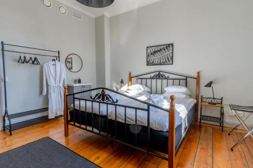 a bedroom with a bed with a black frame at Hotell Gamla Fängelset in Umeå