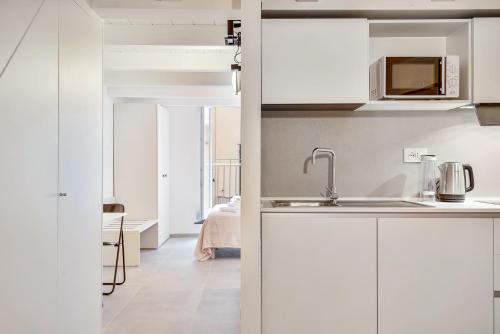 a kitchen with white cabinets and a sink at Via del Mare, Terre Marine in Riomaggiore