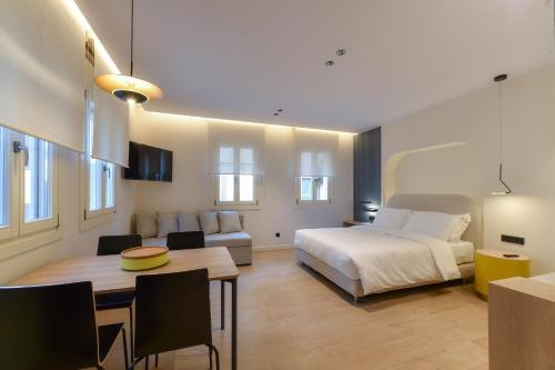 a bedroom with a bed and a dining room at Zalo Urban Living Spaces in Ioannina