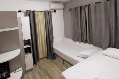 a small room with two beds and a window at Luxury Getaway /Brand New 2BR /Wi-Fi /Full Kitchen in Sharm El Sheikh