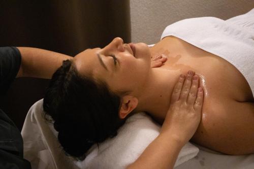 a woman laying on a bed with her head on a pillow at Yomo Eureka in Andorra la Vella