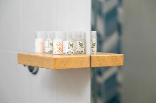 a wooden shelf on a door with cups on it at Agriturismo Casa Marmida in Pardu Atzei