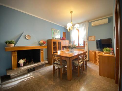 a dining room with a table and a fireplace at Casa Micca - Cielo Terra in San Benedetto del Tronto