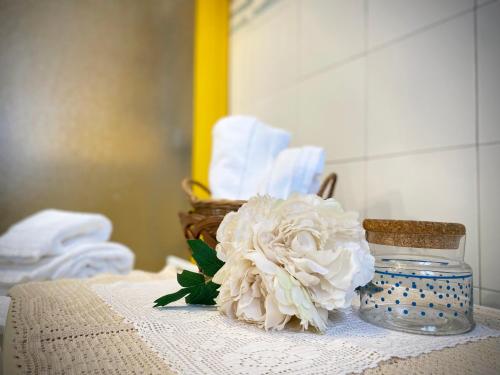 a white flower in a vase on a table at Casa Micca - Cielo Terra in San Benedetto del Tronto