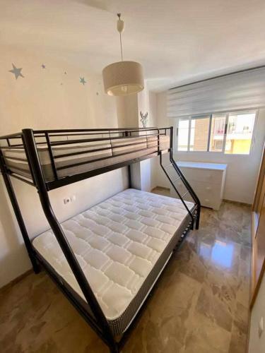 a bedroom with a bunk bed in a room at Frente a Puerto Azahar 2 in Grao de Castellón