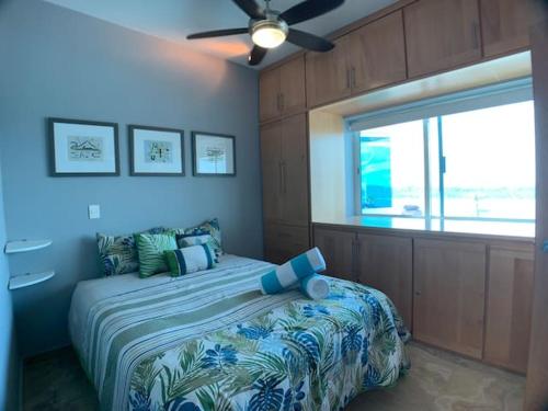 a bedroom with a bed and a ceiling fan at Condos by Malecon I Breathtaking Ocean View in La Paz