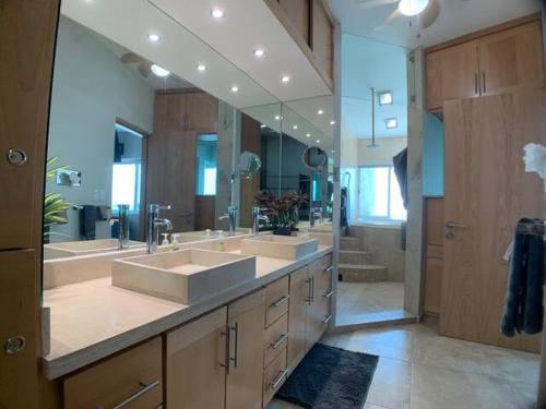 a bathroom with two sinks and a large mirror at Condos by Malecon I Breathtaking Ocean View in La Paz