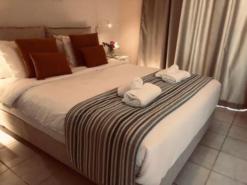 a bedroom with a large bed with towels on it at Princess Hotel in Lassi