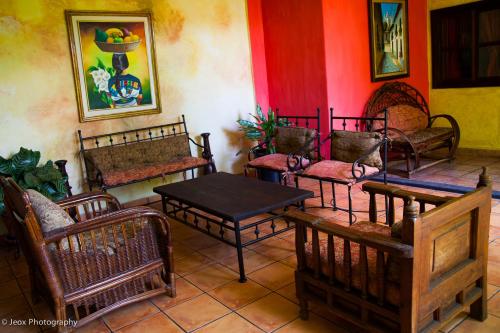 a room full of chairs and tables and a table and chairs at Hotel Camino Maya in Copan Ruinas