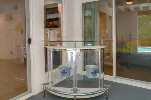 a glass display case with two cups in it at Sunny Palm Springs Home with Private Pool and Patio! in Palm Springs