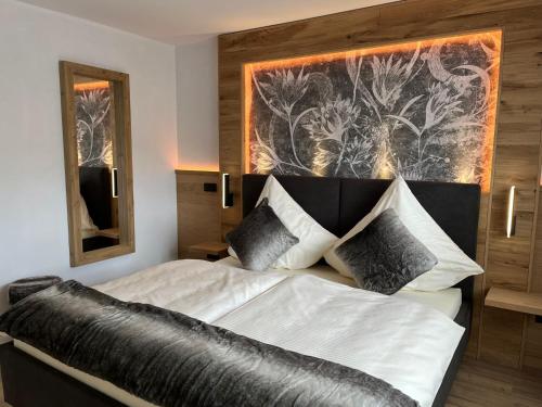 a bedroom with a bed with a black and white headboard at WEiNECK Altenahr in Altenahr