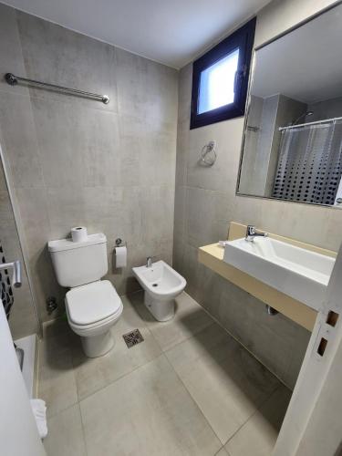 a bathroom with a toilet and a sink at Casita de Tucuman - Blue in San Miguel de Tucumán