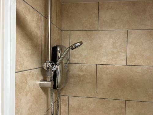 a shower with a phone on a wall at Bigg Market Apartments in Newcastle upon Tyne