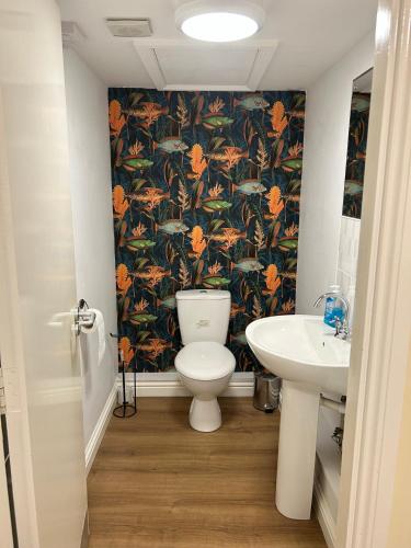 a bathroom with a toilet and a sink at Bigg Market Apartments in Newcastle upon Tyne