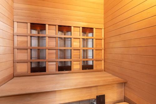a sauna with wooden paneled walls and windows at Ferienhaus Hermine in Tönning