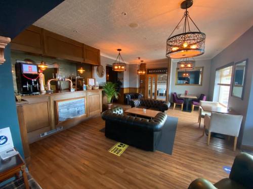 a living room with a couch and a table at The Calder House Hotel in Seascale