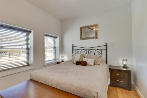 a bedroom with a large bed and two windows at Marlinton Vacation Rental on Riverfront Trail! in Marlinton