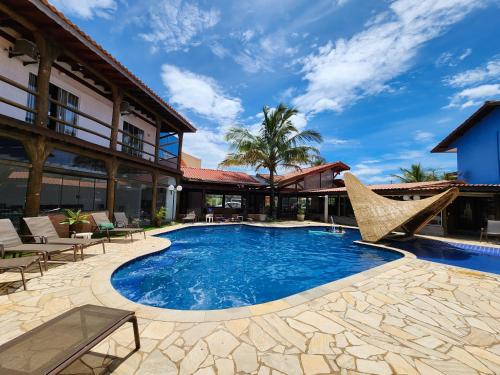 una piscina con sillas y un complejo en Toya Hotel, en Ilha Comprida
