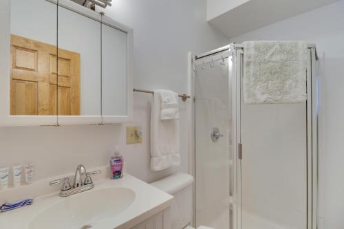 a white bathroom with a sink and a shower at Downtown Marlinton Vacation Rental Apartment! in Marlinton