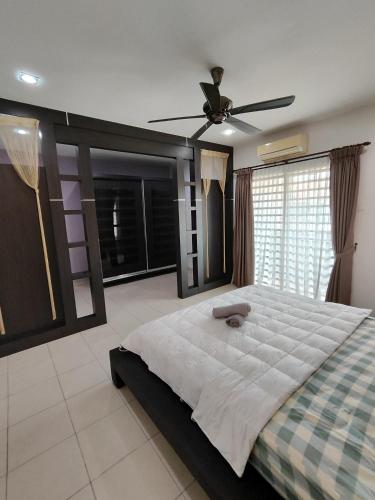 a bedroom with a large bed and a ceiling fan at Ipoh Premium Cozy Relax Home in Ipoh