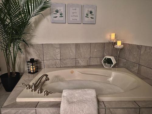 - Baño con bañera y planta en Settlers Suites en Niagara on the Lake