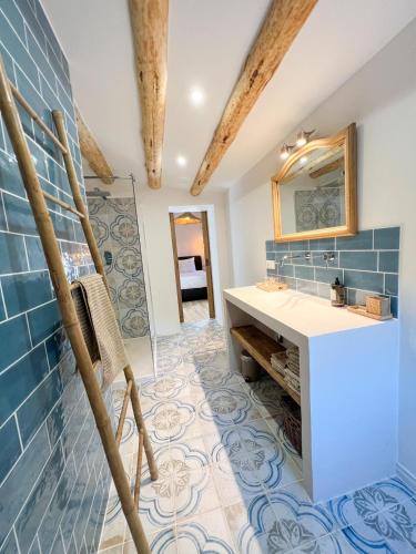 a bathroom with a sink and a mirror at Can Jan Vives in Vidreres