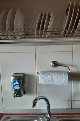 a towel holder on a shelf above a sink at Ultracentral,Parcul Catedralei,apartament 2 camere in Bacău