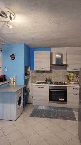 a kitchen with white cabinets and a stove top oven at Paraiso S in Villasimius