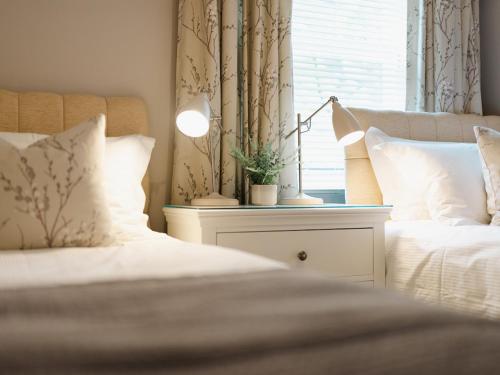 a bedroom with a bed and a lamp on a night stand at Durham Riverside Apartments in Durham
