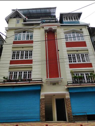 a building with blue doors and red and white at Divine Bliss Homestay in Darjeeling
