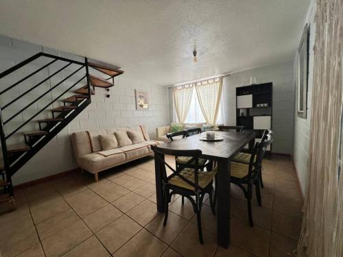 a living room with a table and a couch at Casa en Copiapó + Estacionamiento in Copiapó