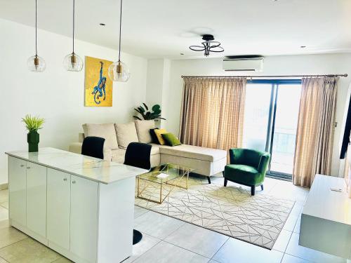 a living room with a couch and a table at The Signature Apartments, Accra Ghana in Accra