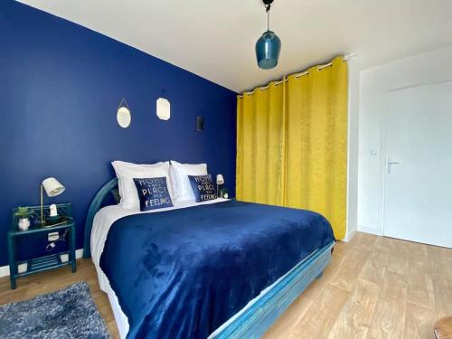a blue bedroom with a bed and a yellow curtain at Mon Saint-Patrice by Melrose in Bayeux