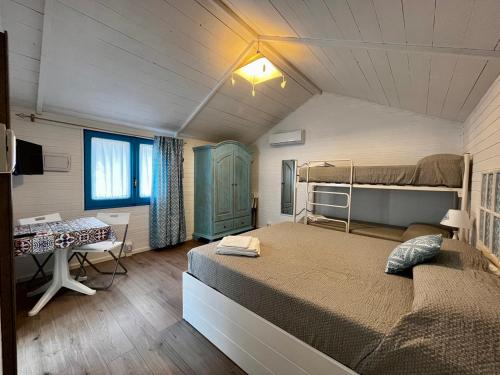a bedroom with a bed and a desk in a room at Camping Car Palmasera in Cala Gonone